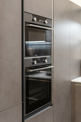 Built-in oven in black modern kitchen cabinet
