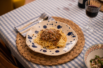 spaghetti bolognese served with wine