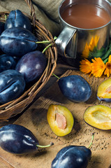 Ripe plum and plum juice in a mug
