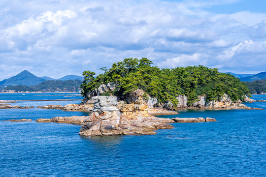 Many small islands over the blue ocean in sunny day, famous Kujukushima(99 islands) pearl sea resort islet in Sasebo Saikai National Park, Nagasaki, Kyushu, Japan.