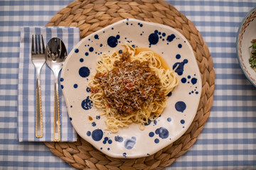 spaghetti bolognese served with wine