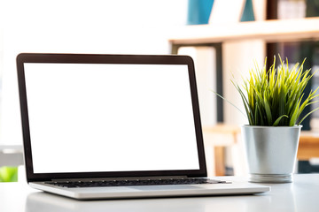 Blank screen Laptop computer and poster workspace background in modern office