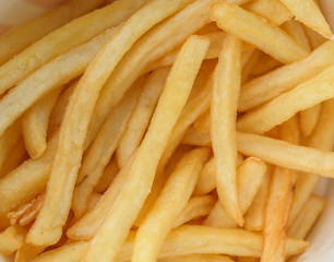 French fries in a paper cup. Selective focus and shallow depth of field.