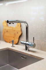 Closed tap over the sink in new kitchen