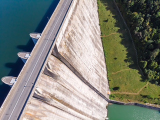 Aerial top down view of a dam constructed on a beautiful valley in mountains. water storage...