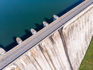 Aerial top down view of a dam constructed on a beautiful valley in mountains. water storage...