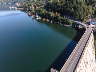 Aerial scenic view of a dam constructed on a beautiful valley in mountains. water storage...