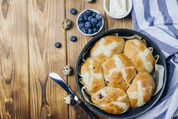 Traditional Easter treats cross buns wwith fresh butter