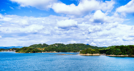 Naklejka premium Many small islands over the blue ocean in sunny day, famous Kujukushima(99 islands) pearl sea resort islet in Sasebo Saikai National Park, Nagasaki, Kyushu, Japan.