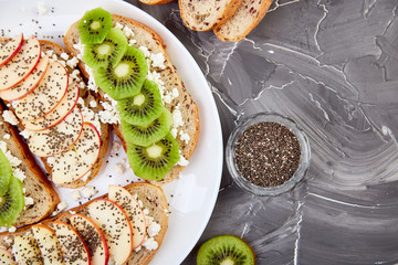 Healthy breakfast toasts with kiwi, apple, cottage cheese and chia seeds