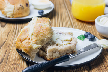 Traditional Easter treats cross buns wwith fresh butter