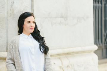 Young black long hair brunette woman resting in an urban scene.