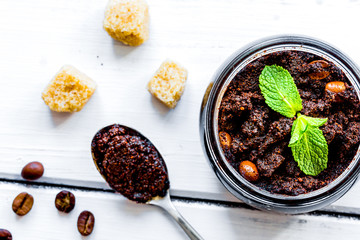 Organic scrub from ground coffee on table background top view