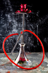 rose aroma hookah. hookah decorated with flowers on dark background