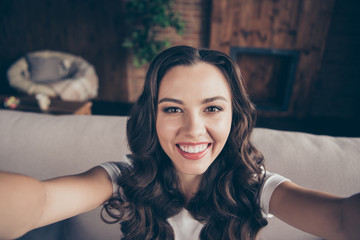 Fototapeta premium Close up photo beautiful brunette she her lady laugh laughter make take selfies excited toothy sincere kindhearted pretty wearing domestic light color t-shirt clothes outfit sit comfy divan