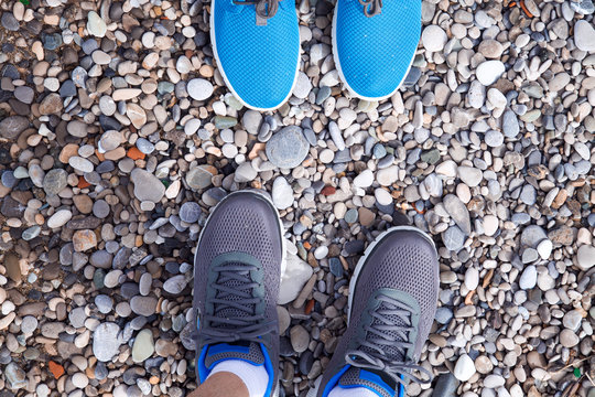 Close Up On Legs Of Two People Facing Each Other On The Beach.