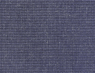 The textured dark-blue natural fabric.