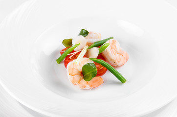 Serving Tom Yam Soup: Chef lays cherry tomatoes, king prawns, green beans and greens before serving soup