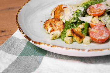 Shrimp Caesar salad with Parmesan cheese, croutons and lettuce