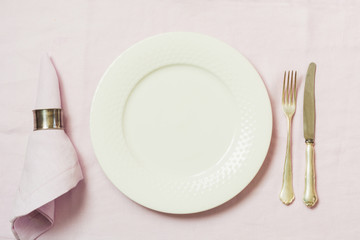 Romantic dinner. Elegance table setting flowers on tablecloth.