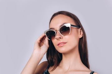 Naklejka premium Beautiful smart serious fashionable professional model posing in studio. Business, fashion, beauty concept