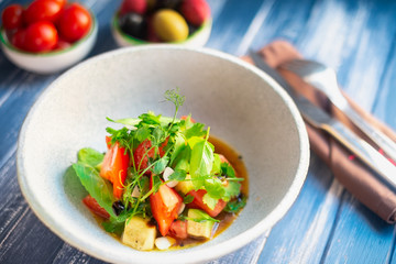 Light fresh vegetable salad of tomatoes, radishes and greens. Diet and healthy food