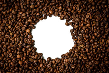 Roasted brown coffee beans scattered on white table with a lot copy space for text. Flat lay composition. Close up, top view, background. 