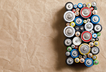 Used Alkaline batteries on recycled paper toxic waste recycling and ecology issues concept background