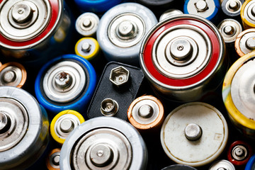 Used Alkaline batteries toxic waste recycling and ecology issues concept background