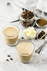 Keto bulletproof coffee in glasses. Selective focus, space for text.
