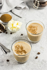 Keto bulletproof coffee in glasses. Selective focus, space for text.