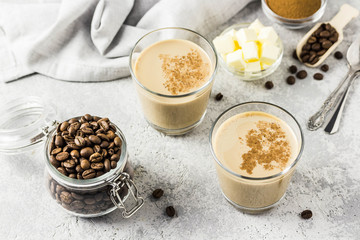 Keto bulletproof coffee in glasses. Selective focus, space for text.