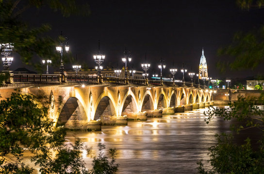 Night view of The Pont de Pierre, bridge over the Garonne river in Bordeaux city, France