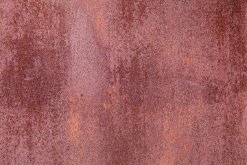 Old painted metal surface. Rusty metal, peeling paint, red tones. Worn metallic iron panel.