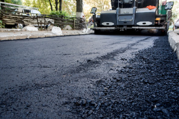 Obraz premium Laying of new asphalt. The new road. Road repair street.