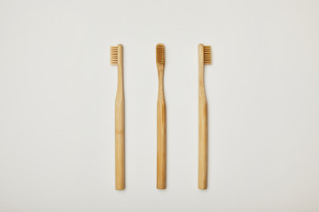 top view of bamboo toothbrushes on white background