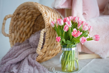 Delicate bouquet of pink tulips. Wicker basket.