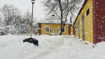 City service cleaning snow winter with shovel after snowstorm yard.