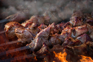 Barbecue skewers meat kebabs on flaming grill