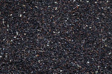 close up integral uncooked heap of raw jasmine brown rice scattered out texture.  top view