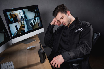 handsome guard in uniform sleeping at workplace