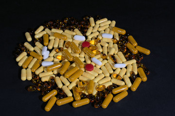 Assortment of pills on black background