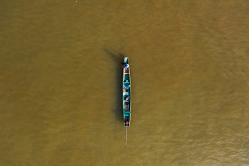 (View from above) Stunning aerial view of a traditional long-tail boat sailing on the Mekong river, Luang Prabang, Laos.