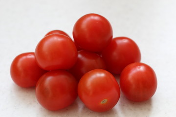 bunch of Cherry red tomatoes isolated on table.