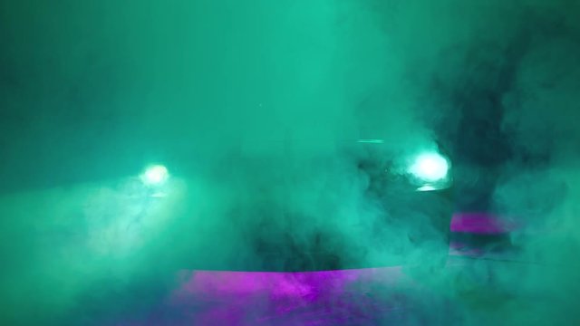 Silhouette of beautiful american muscle car on smoked dark background . Car lights on fog . 