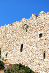 Close-up of stone wall with battlements of the ruins of Kritinia castle, Kritinia village, Rhodes island, Greece