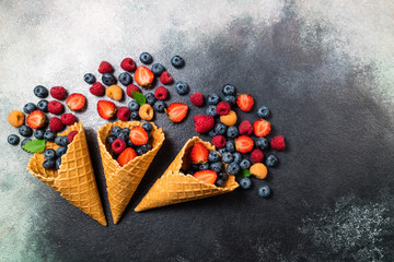 Fresh berries in ice cream cone. Strawberry, raspberry, blueberry for dessert. Concept for healthy...