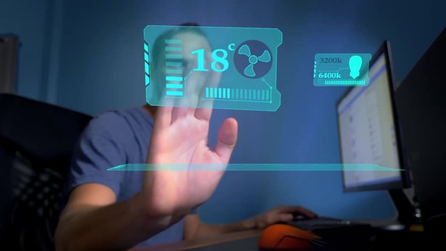 Smart House. concept of remote control of home automation technology. a man sitting in an office controls on the virtual screen the functions of air conditioning and room lighting.