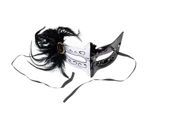 black and white theatrical masquerade venetian mask with feathers on a white background