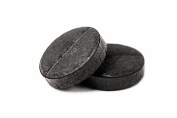 activated carbon tablets isolated on white.
